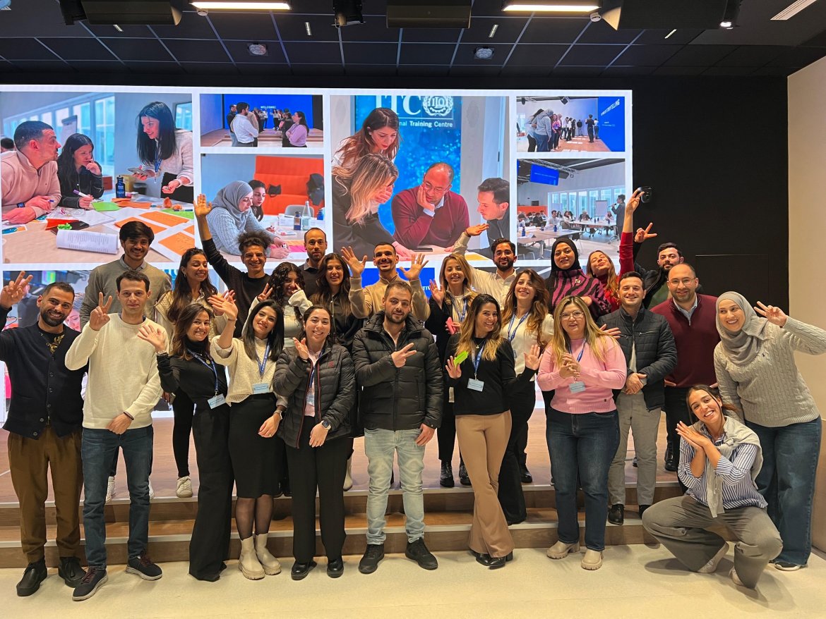 full cohort of Palestinian participants posing in a group photo in the itcilo innovation lab