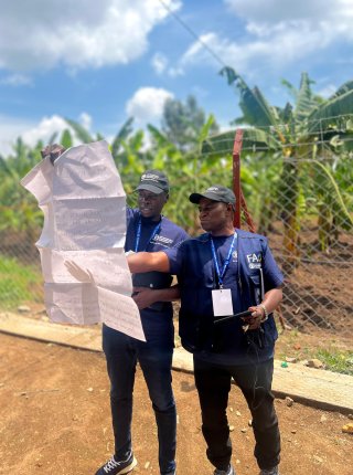 two participants looking at a large format paper together in the field