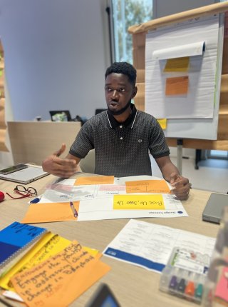 participant at a table surrounded by post its and other materials