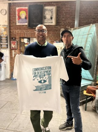 participant showing the print screen shirt that he made